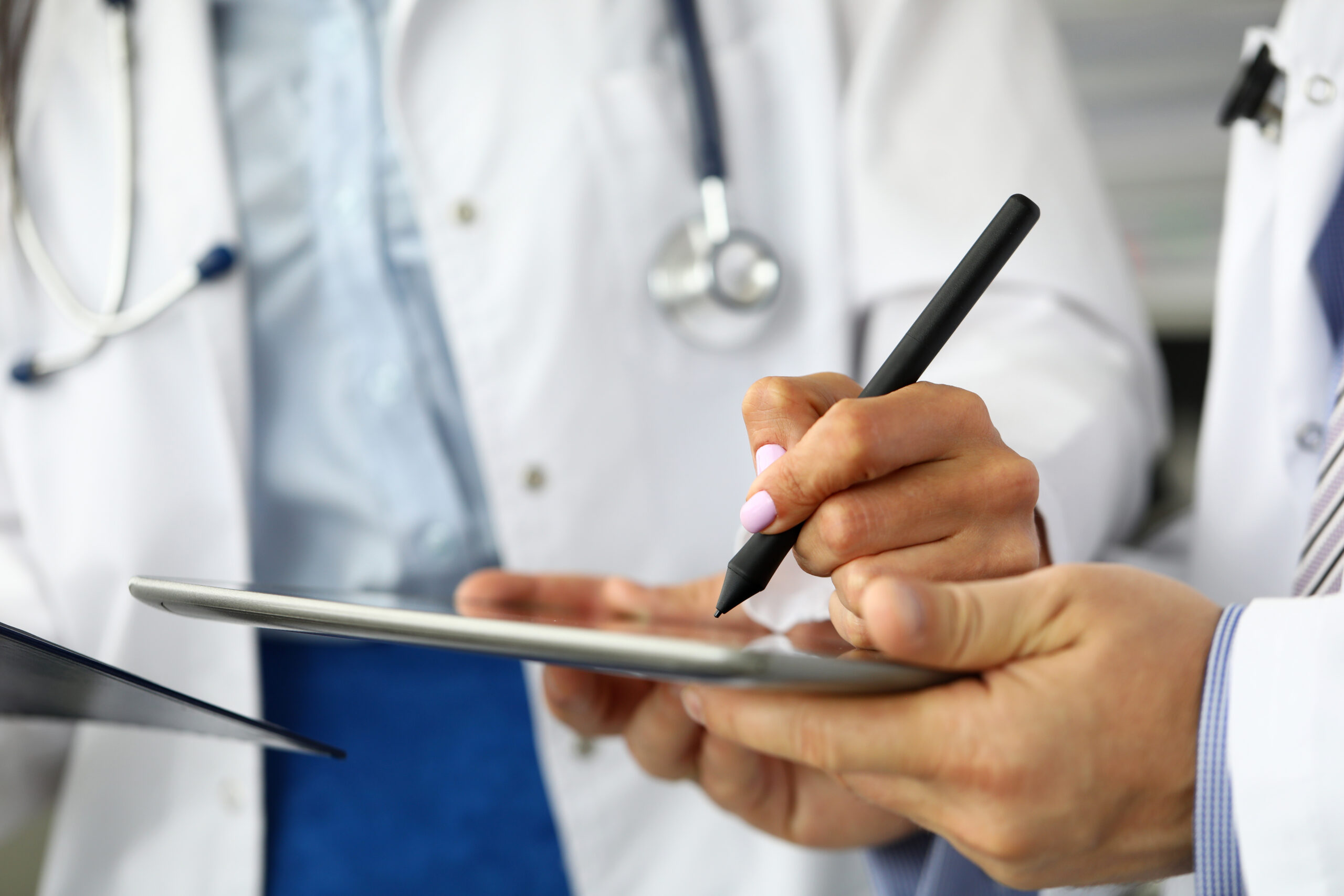 Female GP making electronic notes in tablet pc